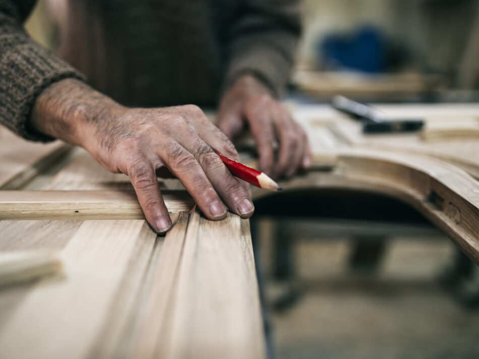 Close up shot of old master carpenter working in his woodwork or workshop